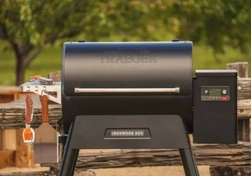 A grill sitting on top of a wooden table.