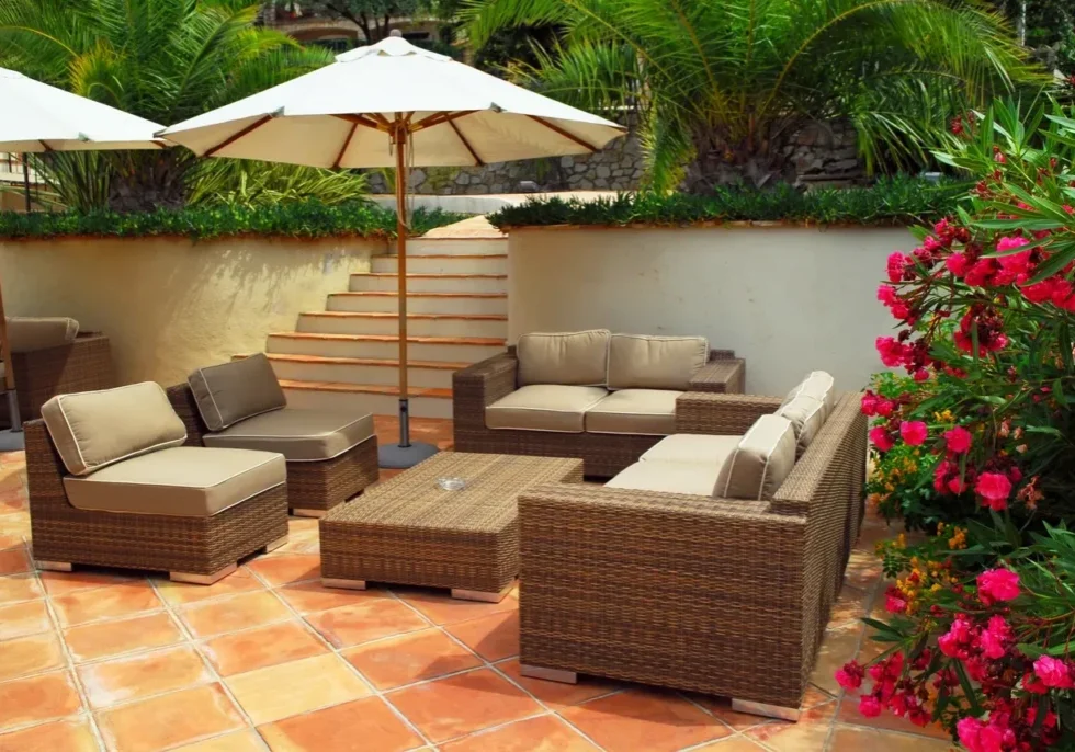 A patio with furniture and an umbrella.